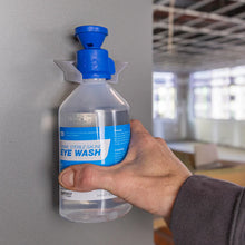 Load image into Gallery viewer, Hand holding a bottle of eye wash solution in an indoor setting