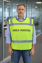 Load image into Gallery viewer, Man wearing a yellow safety tabbard style vest with 'AREA WARDEN' text in an office setting