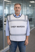 Load image into Gallery viewer, Man wearing a white safety tabbard style vest with 'CHIEF WARDEN' text in an office setting